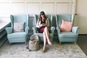 Shannon Christensen, founder of Mamas for Mamas sits on bright blue chairs